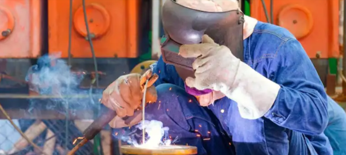Industrial welding operation — consumables and protective gear stocked at Holmes Auto Supply, Decatur TX