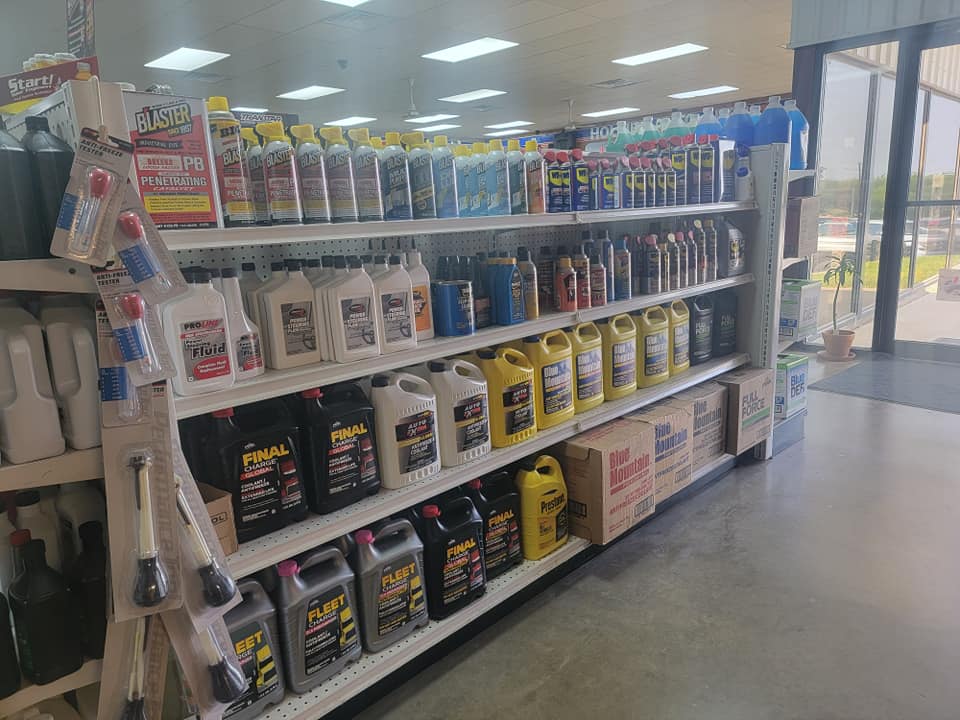 Holmes Auto Supply store aisle stocked with fluids, maintenance supplies, and automotive chemicals in Decatur, TX
